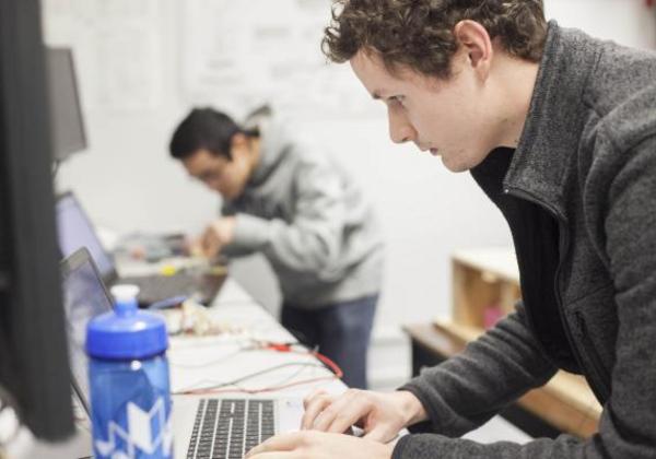 Two young men working in a computer lab